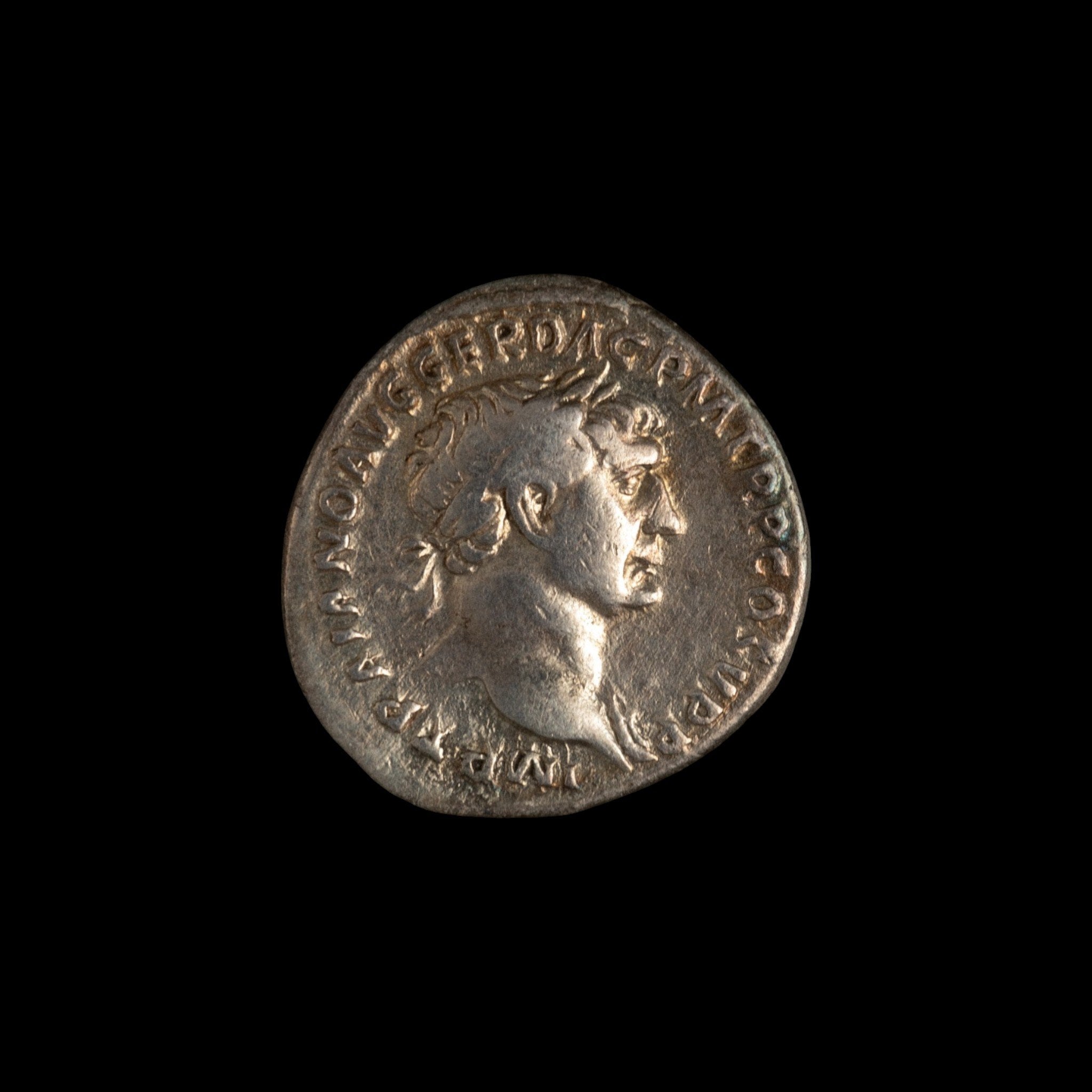 Obverse of Roman silver denarius of Trajan, legend IMP TRAIANO AVG GER DAC P M TR P COS V P P, radiate or laureate bust right.
