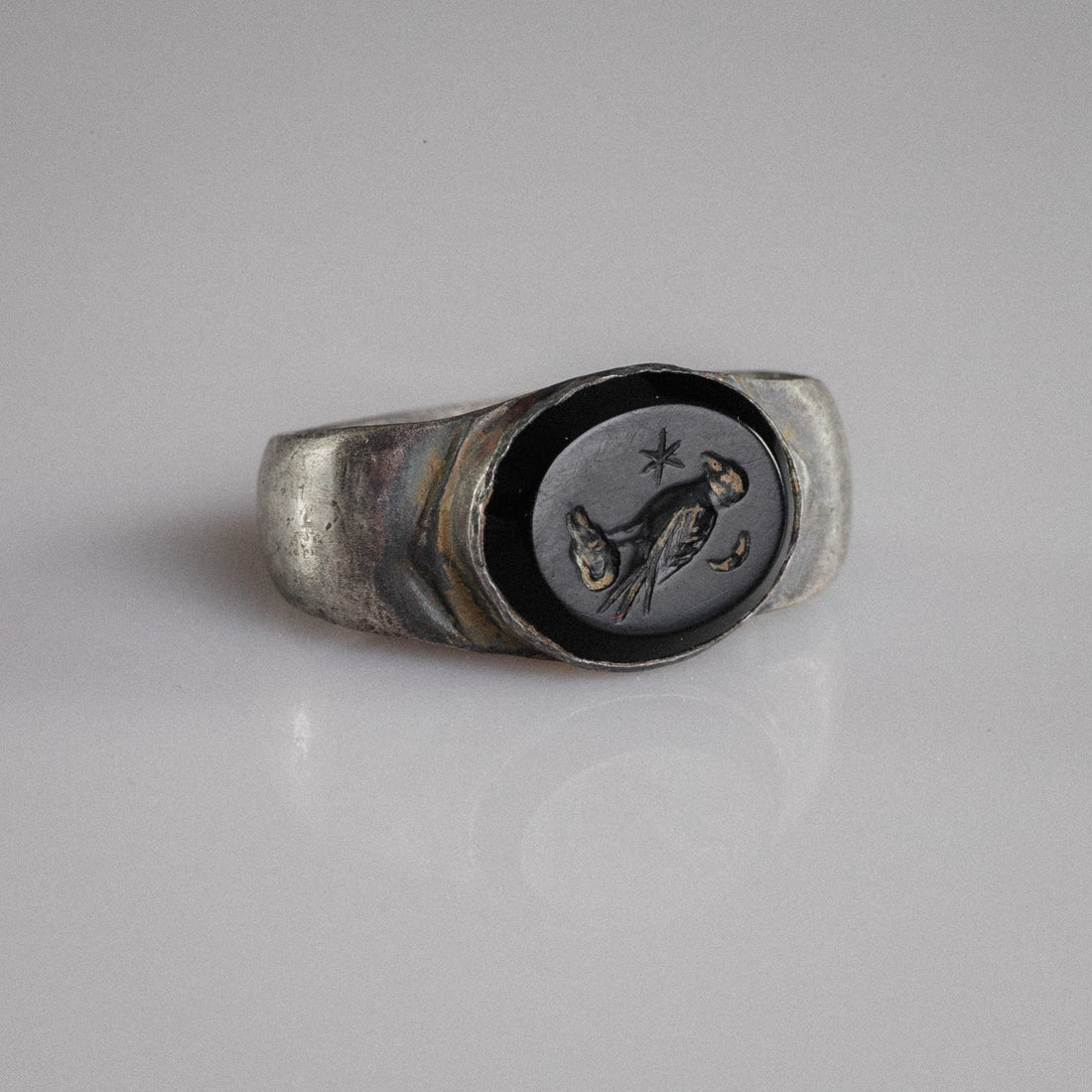 Roman silver signet ring Numerius Aquilus with eagle, star and crescent intaglio on dark stone