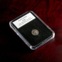 Roman silver denarius of Trajan in protective slab with catalog label.