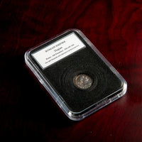 Roman silver denarius of Trajan in protective slab with catalog label.