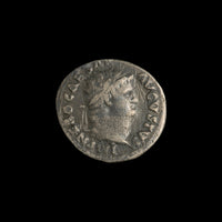 Obverse of Roman silver denarius of Nero, legend IMP NERO CAESAR AVGVSTVS, radiate or laureate bust right.