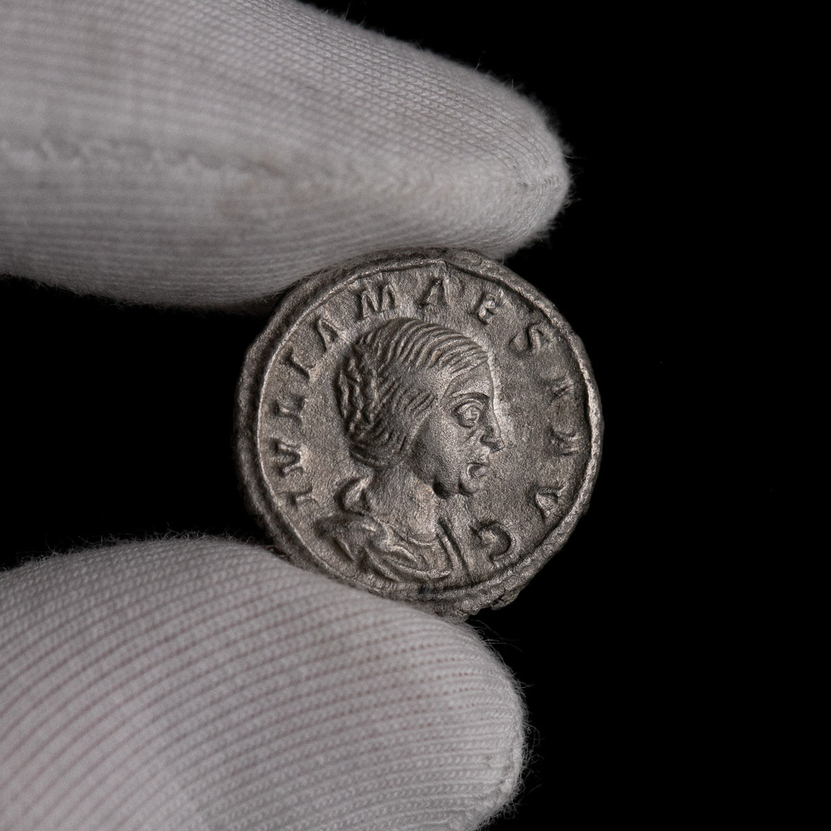 Macro detail of Roman silver denarius of Julia Maesa, portrait close-up.