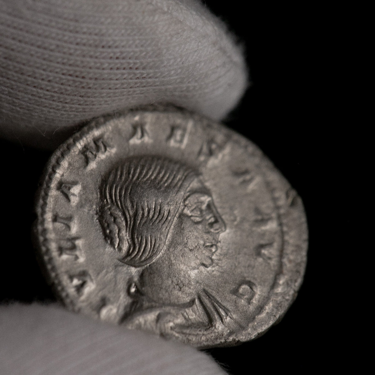 Macro detail of Roman silver denarius of Julia Maesa, portrait close-up.