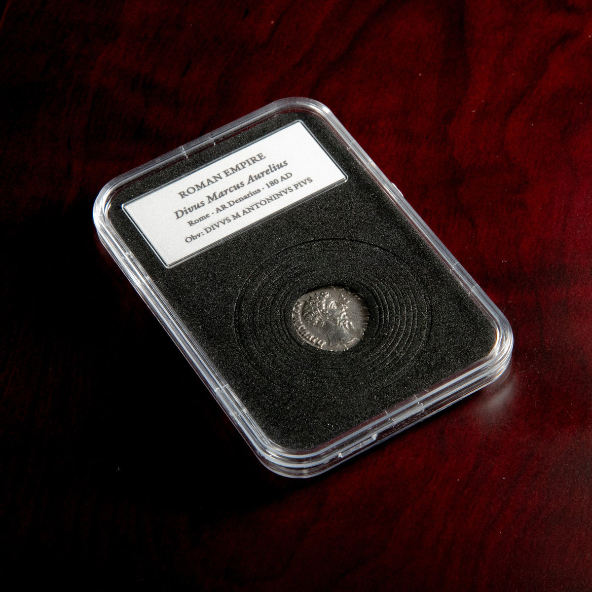 Roman silver denarius of Divus Marcus Aurelius (under Commodus) in protective slab with catalog label.