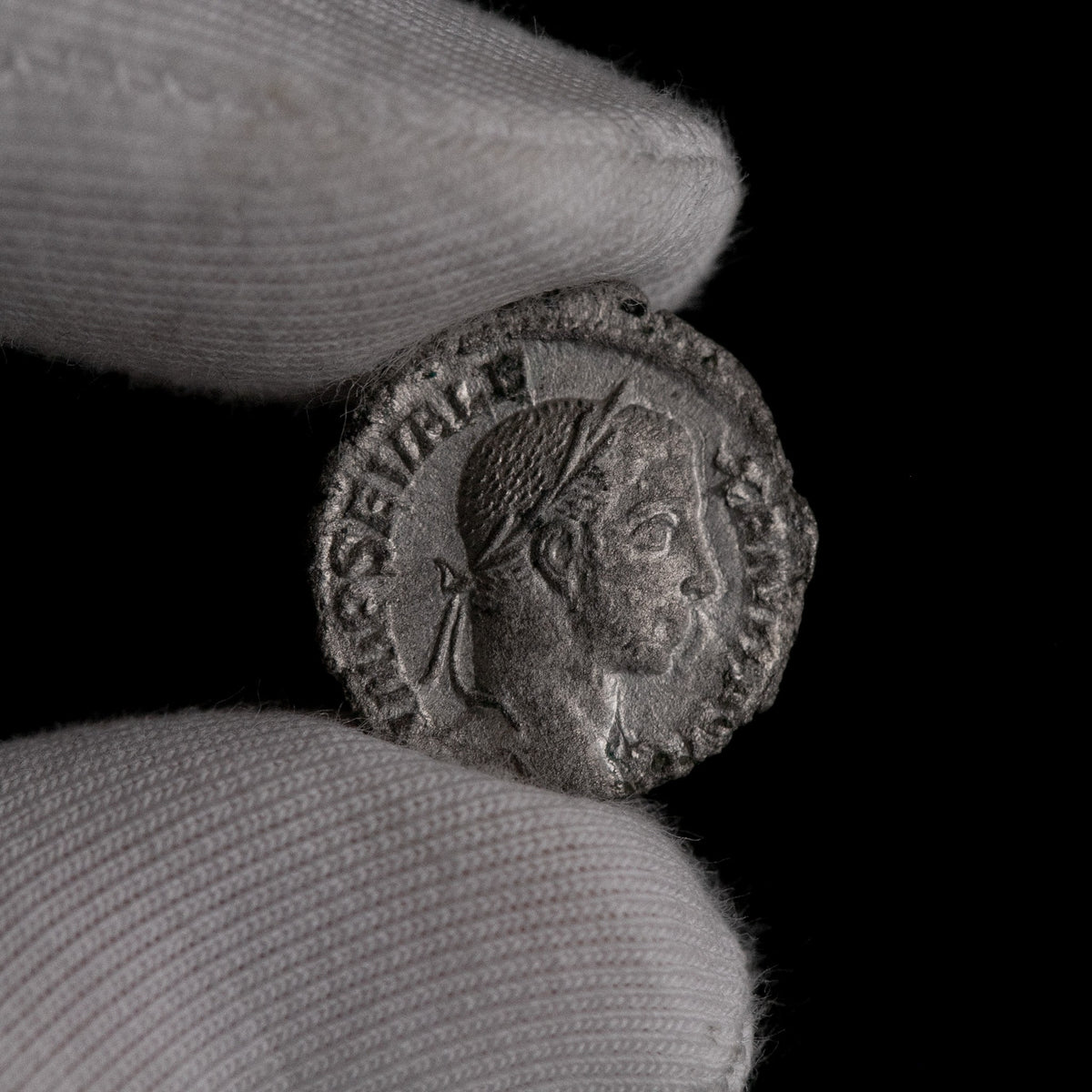 Macro detail of Roman silver denarius of Severus Alexander, portrait close-up.