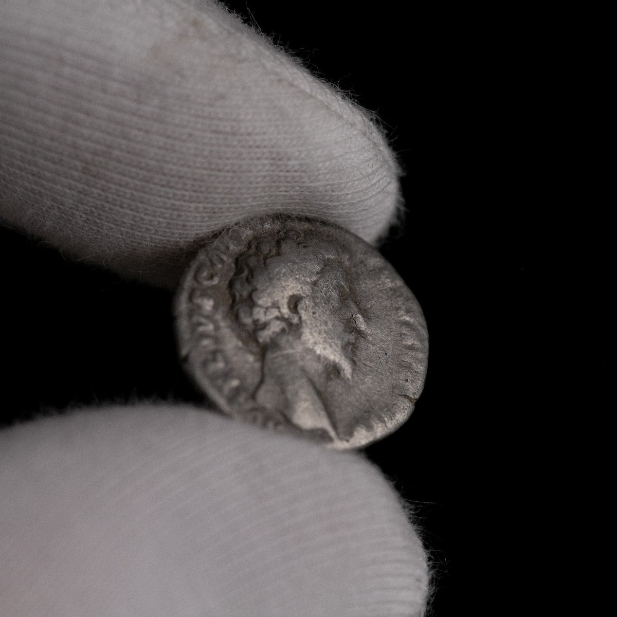 Macro detail of Roman silver denarius of Marcus Aurelius (Caesar), portrait close-up.