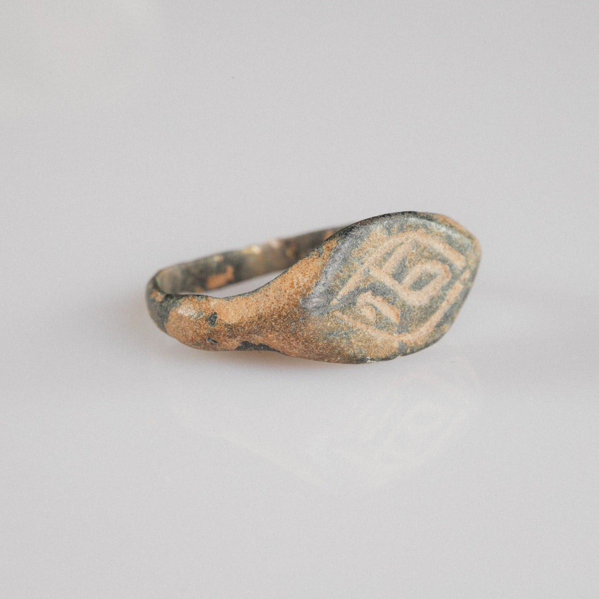 Medieval bronze ring Aldren, three-quarter view showing tapered shoulders and cuprite patina