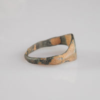 Medieval bronze signet ring Aldren, side profile revealing thin D-section hoop and burial patina