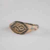 Medieval bronze ring Aldren, angled top-down view of monogram engraving inside lozenge border
