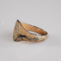 Medieval bronze signet ring Falco, opposite three-quarter view of bezel and shoulder