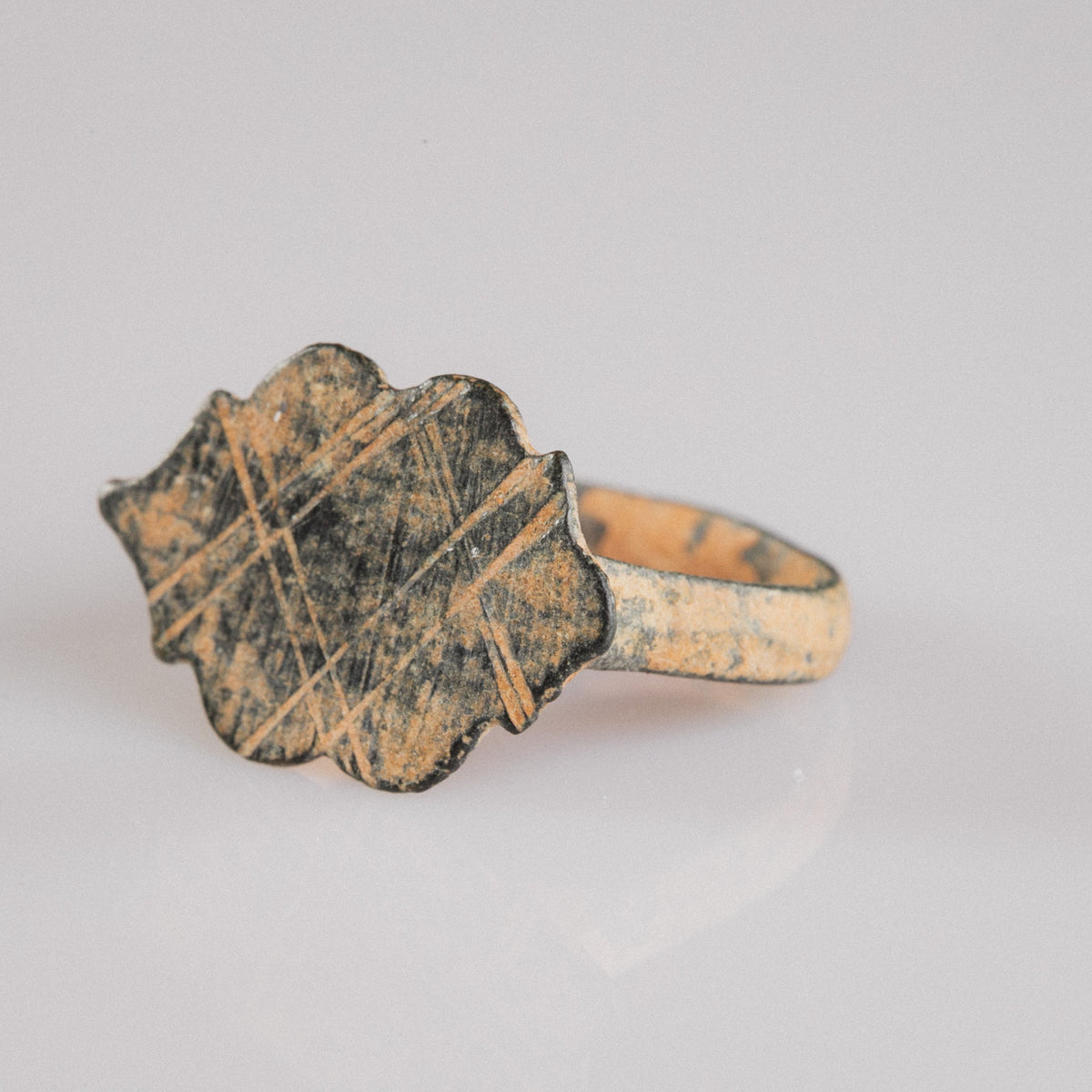 Medieval bronze ring Vladica close-up on gloved hand showing geometric engraving detail