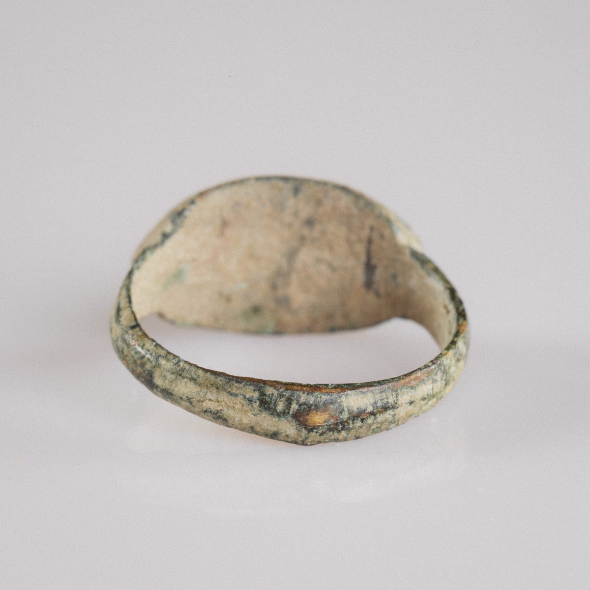 Interior view of Roman bronze signet ring Numerius Secundus showing hoop wear and soil encrustation