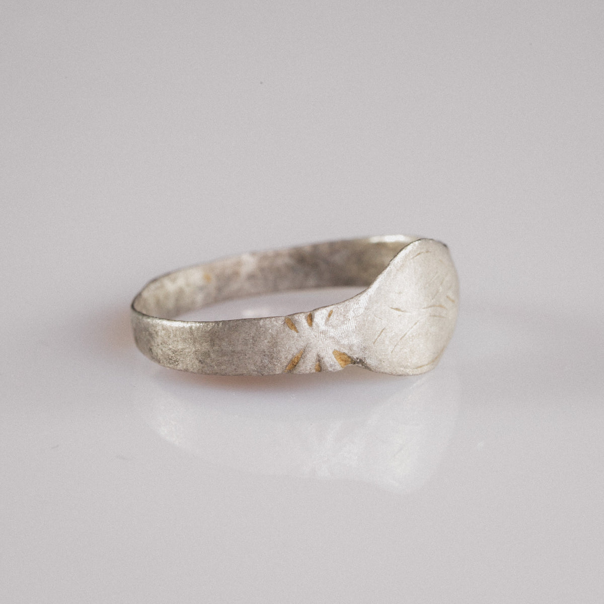 Side profile of Medieval silver ring Aldwin showing radiating star motif on shoulder