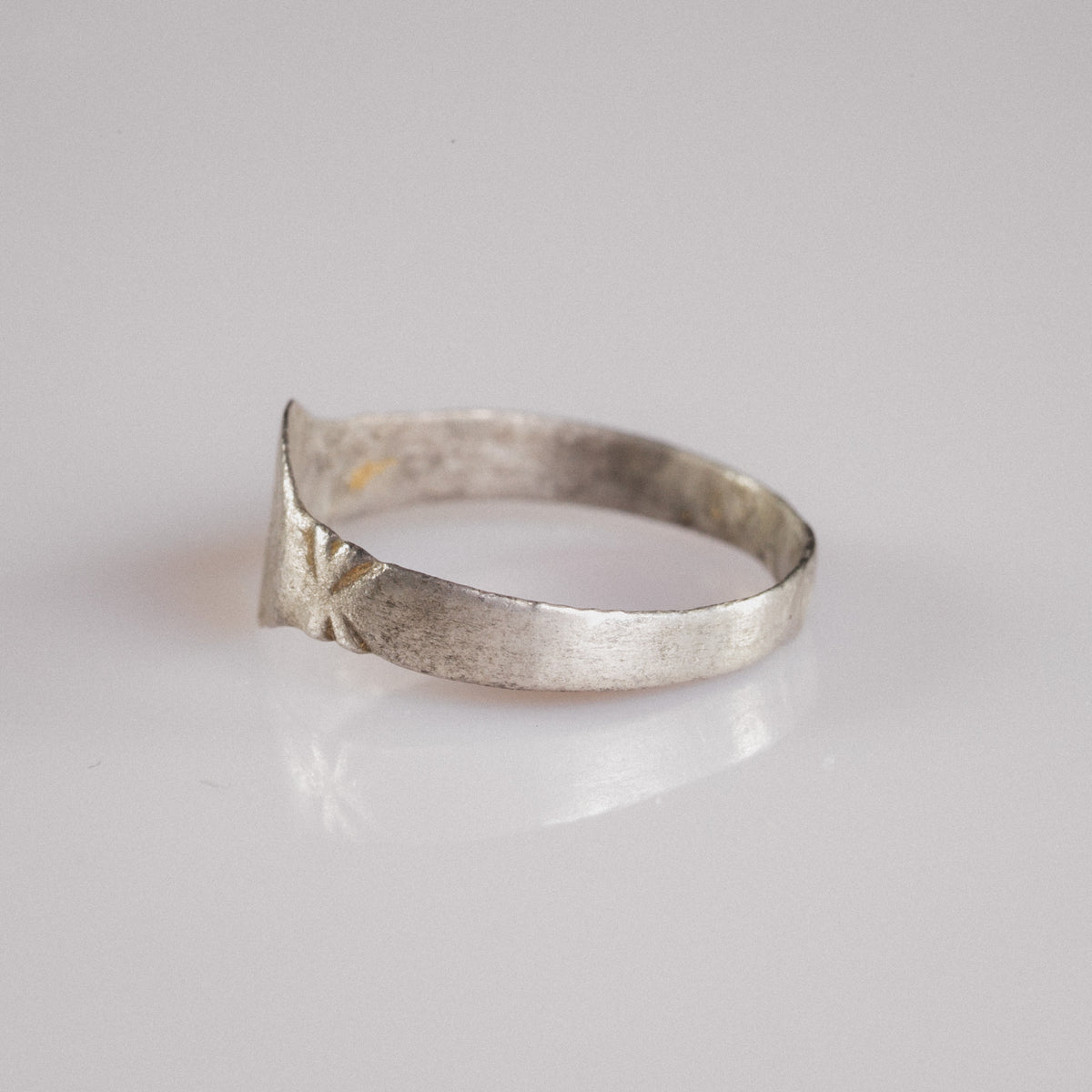 Opposite side of Medieval silver ring Aldwin with star-burst shoulder decoration