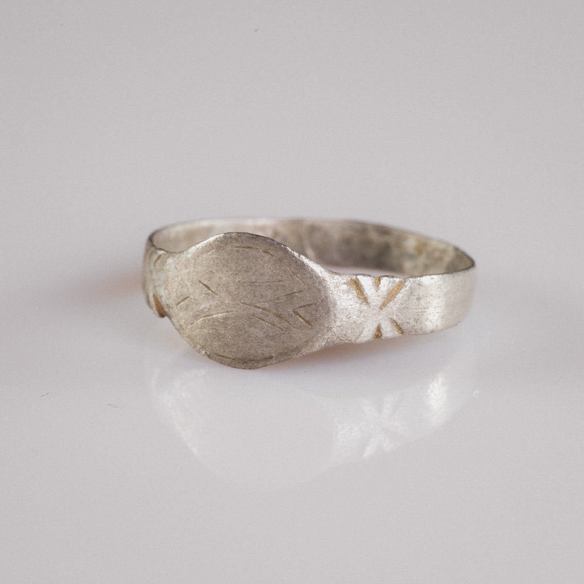 Angled view of Medieval silver signet ring Aldwin showing navette bezel and shoulder engraving