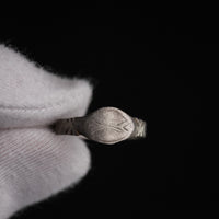 Macro of Medieval silver signet ring Aldwin bezel with incised monogram device
