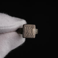 Byzantine silver ring Theofanis held in gloved hand, bezel face and cross-like motif visible