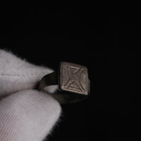 Dramatic low-light study of Byzantine silver ring Theofanis highlighting bezel engraving