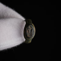 Close-up of Numerius Faber Roman bronze ring showing engraved standing figure intaglio