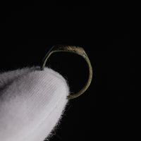 Side profile of Roman bronze ring Numerius Faber displaying D-section hoop and patina