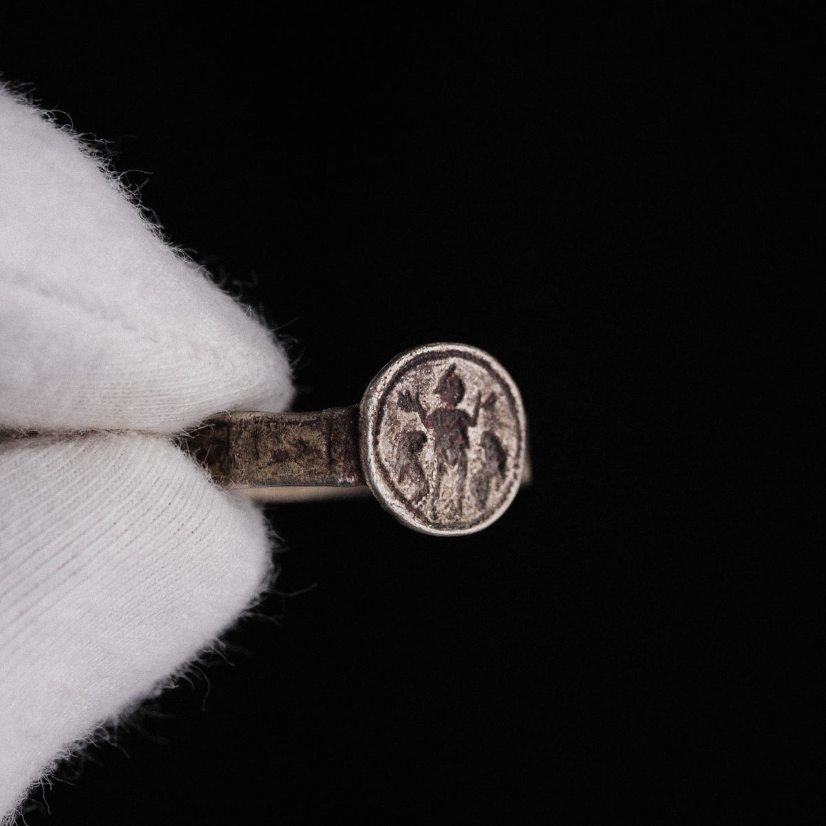 Close-up of Danielos ring bezel with central orant figure flanked by two animals
