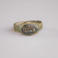 Roman bronze signet ring Numerius Faber, top view of figural intaglio bezel with malachite patina