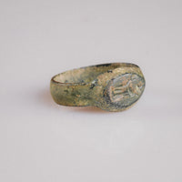 Three-quarter view of Roman bronze ring Numerius Faber showing integral cast bezel and shoulders