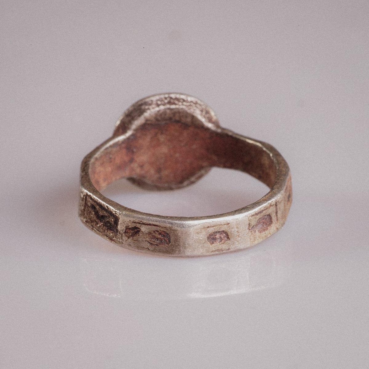 Interior view of ring Danielos revealing cuprite-red copper oxide patina of billon alloy