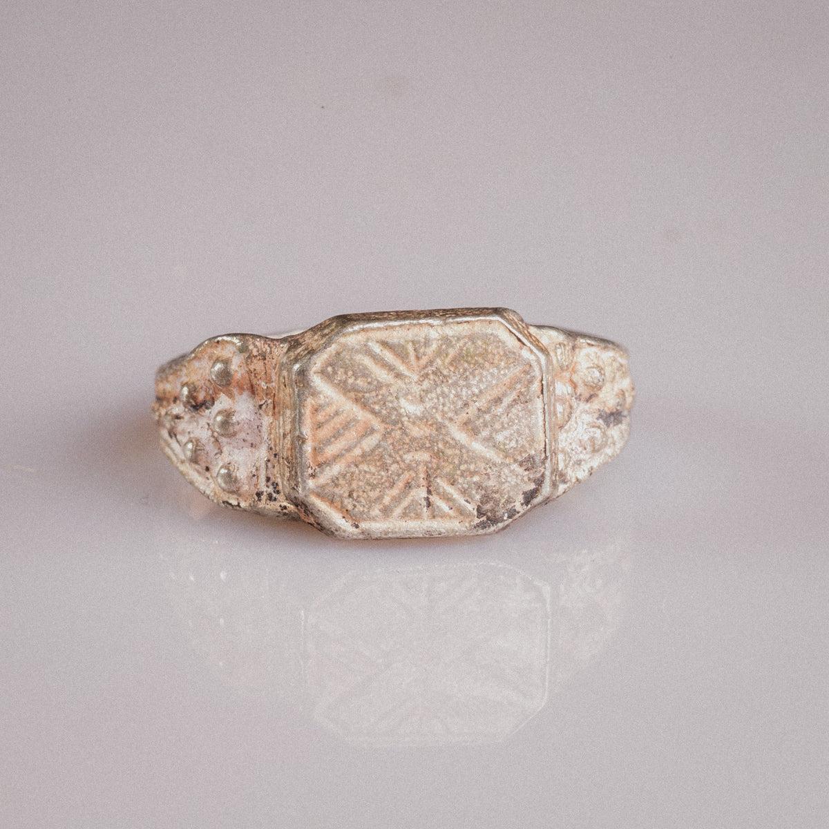 Medieval silver ring Vasilisa top view revealing geometric eight-pointed star engraving and patina