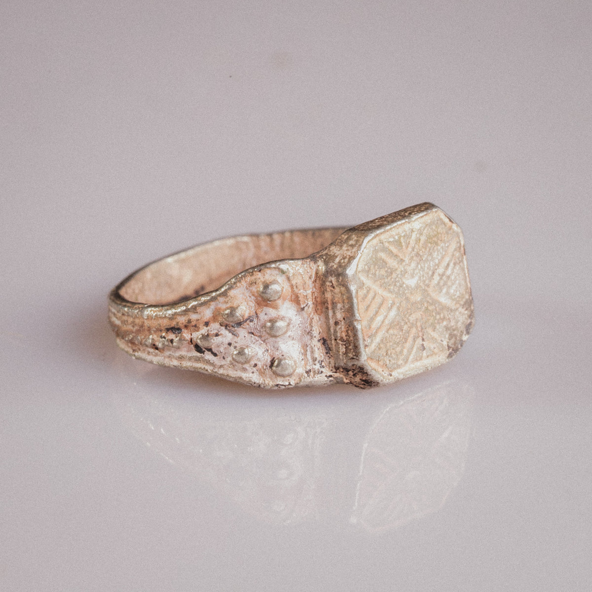 Side angle of Vasilisa silver signet ring showing applied granulation on shoulder and ribbed hoop