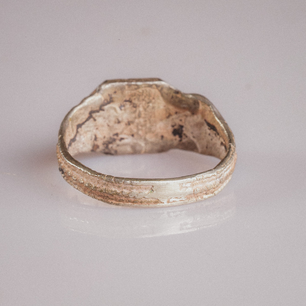 Interior view of Vasilisa silver ring showing hoop profile and cuprite breakthrough from billon alloy