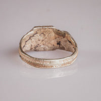 Interior view of Vasilisa silver ring showing hoop profile and cuprite breakthrough from billon alloy