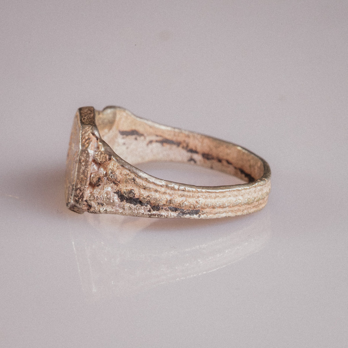 Three-quarter view of Vasilisa medieval silver signet ring showing bezel corner and shoulder detail