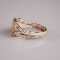 Three-quarter view of Vasilisa medieval silver signet ring showing bezel corner and shoulder detail