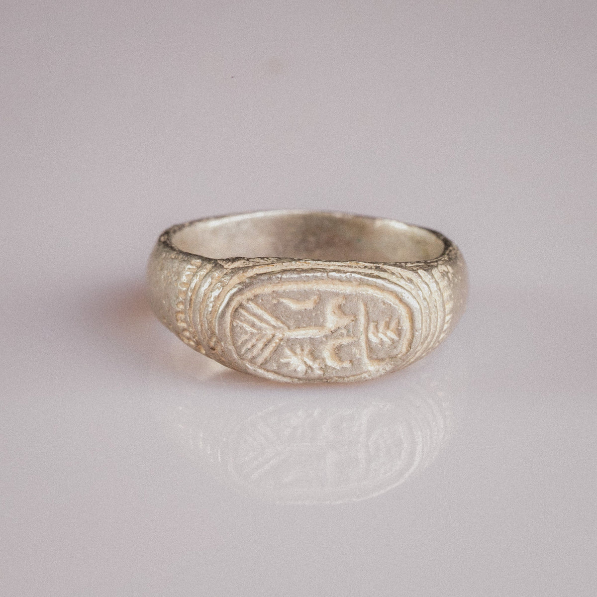 Medieval silver ring Merrick, top view of merchant's mark engraving with concentric bezel frame