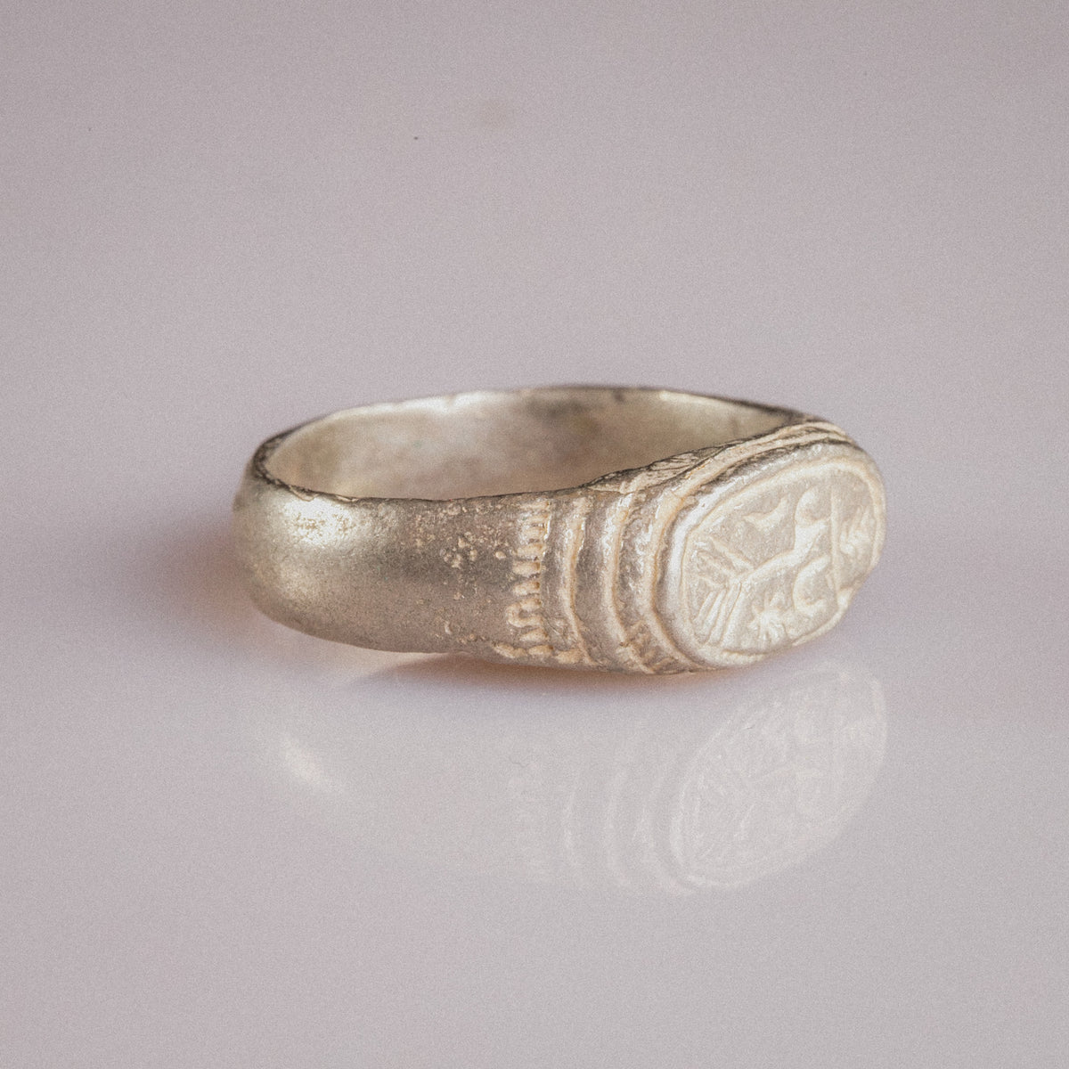 Medieval silver signet ring Merrick, side view revealing grooved shoulder decoration and patina