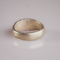 Medieval silver signet ring Merrick, angled view of bezel and shoulder transition details