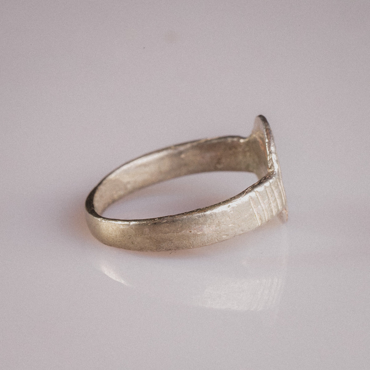Rear view of medieval silver signet ring Lysenne showing unfinished bezel reverse