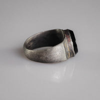 Side profile of Roman silver ring Numerius Aquilus showing tapering D-section hoop and collet bezel