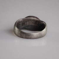 Back view of Roman silver ring Numerius Aquilus revealing hand-formed hoop and aged patina