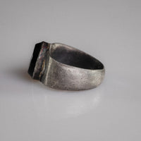 Angled view of Roman silver ring Numerius Aquilus with intaglio of eagle gripping ram's head