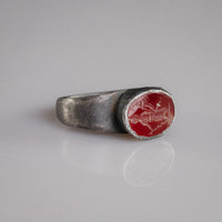 Roman silver ring Sereia three-quarter view showing raised oval garnet bezel and engraved figure
