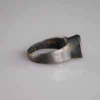Side profile of Roman silver ring Sereia showing flat-section tapering hoop and box-collet setting