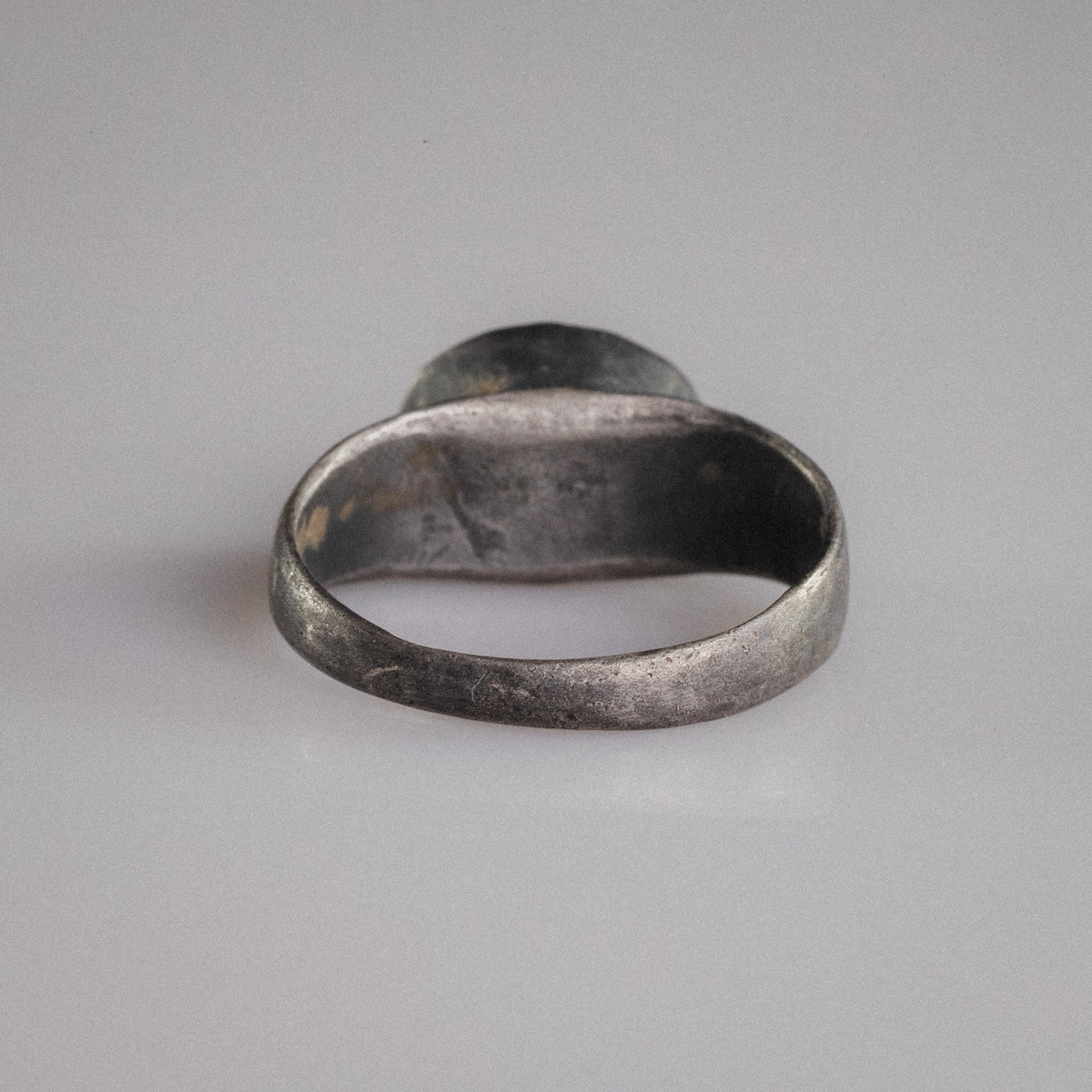 Interior view of Roman silver ring Sereia showing original patina and burial deposits inside the hoop