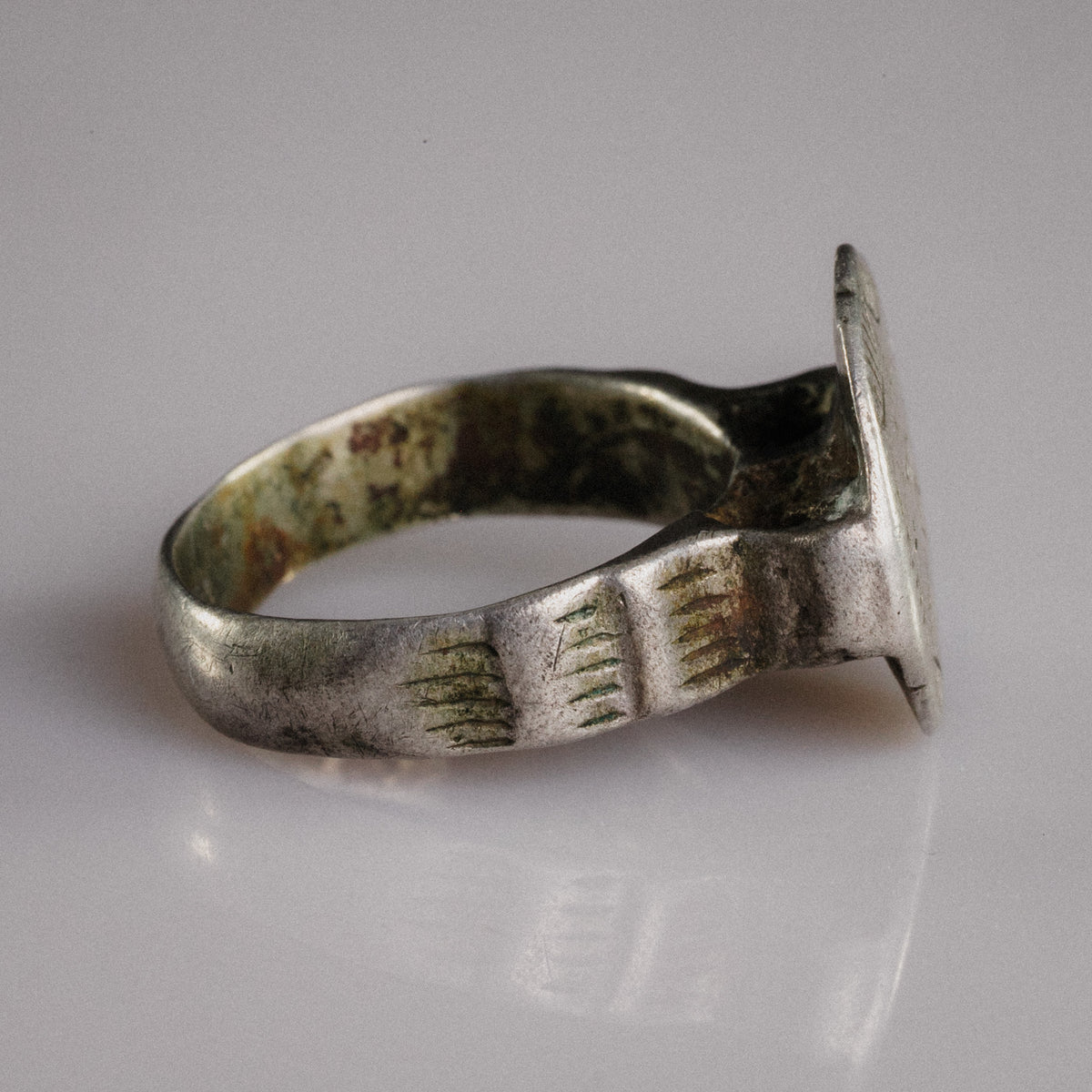 Profile of Byzantine-Balkan silver ring Stavros revealing hoop patina and bezel construction
