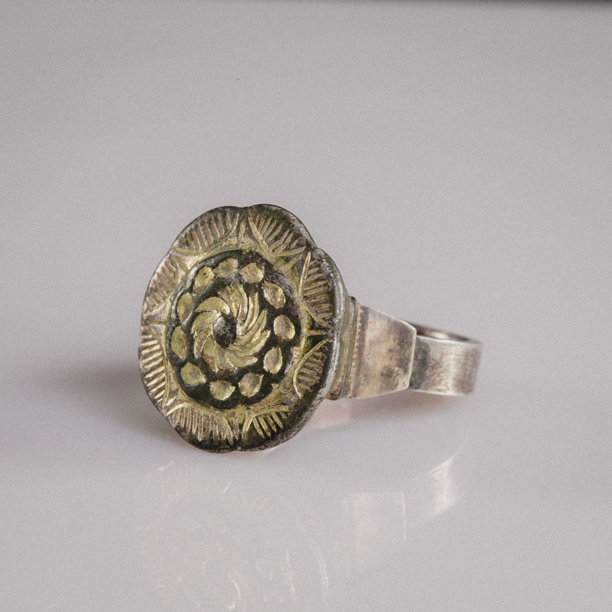 Detail of Islamic silver ring Gulizar with chased spiral rosette and scalloped sunburst border