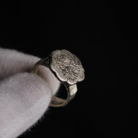 Macro detail of Florian medieval silver ring showing crisp engraved star and hatched radiating strokes