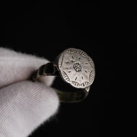 Close-up of medieval silver ring Stavros showing crisp cross-in-circle engraving in hand