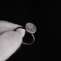 Macro detail of Byzantine silver ring Crucia engraved cross and patina