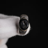 Close-up of Roman silver ring Numerius Aquilus showing eagle, six-pointed star and crescent moon